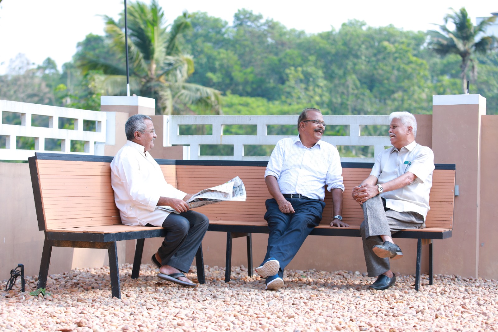 Residents sitting together on a bench and talking