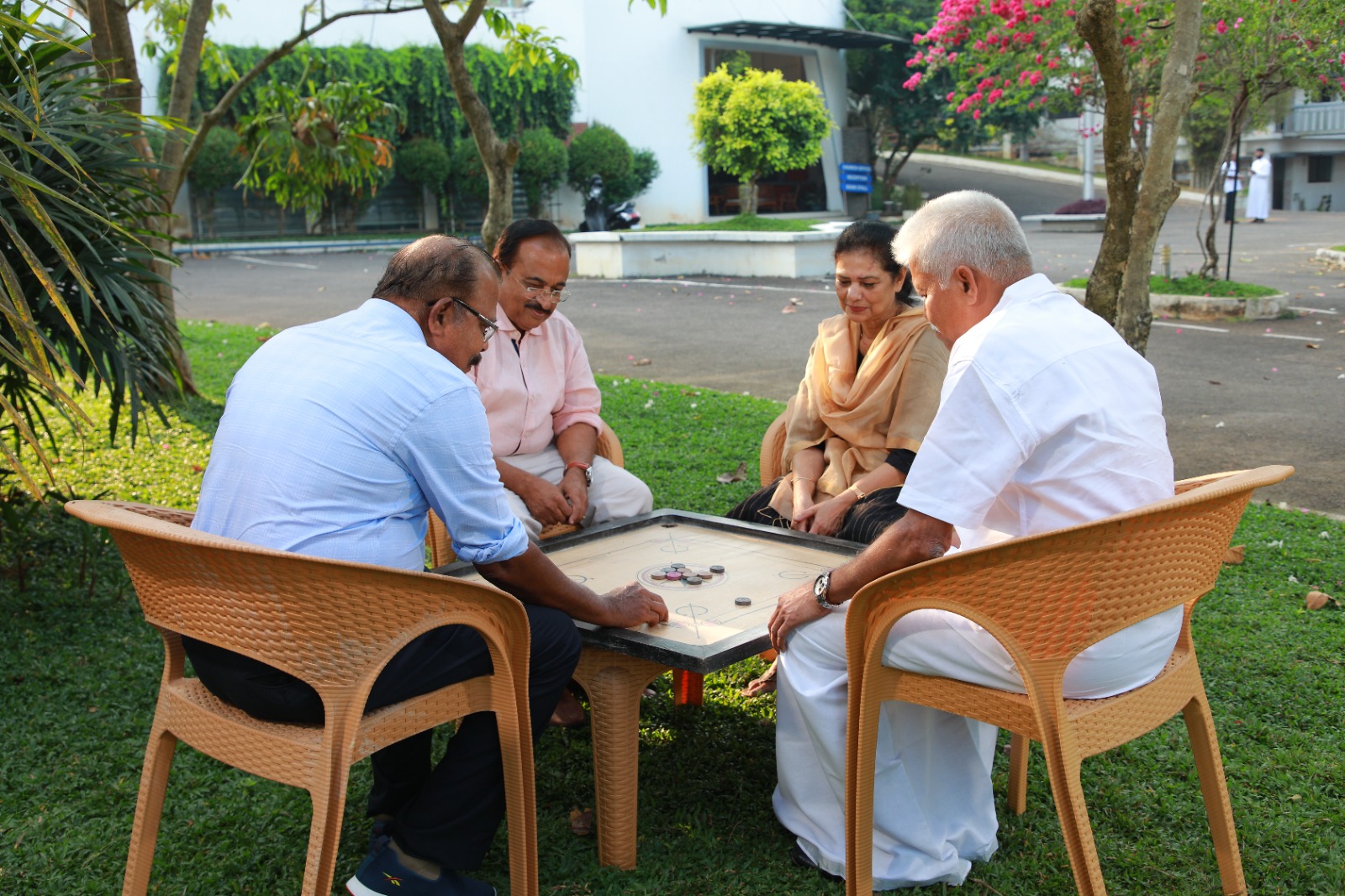 Residents focused on playing a board game outdoors